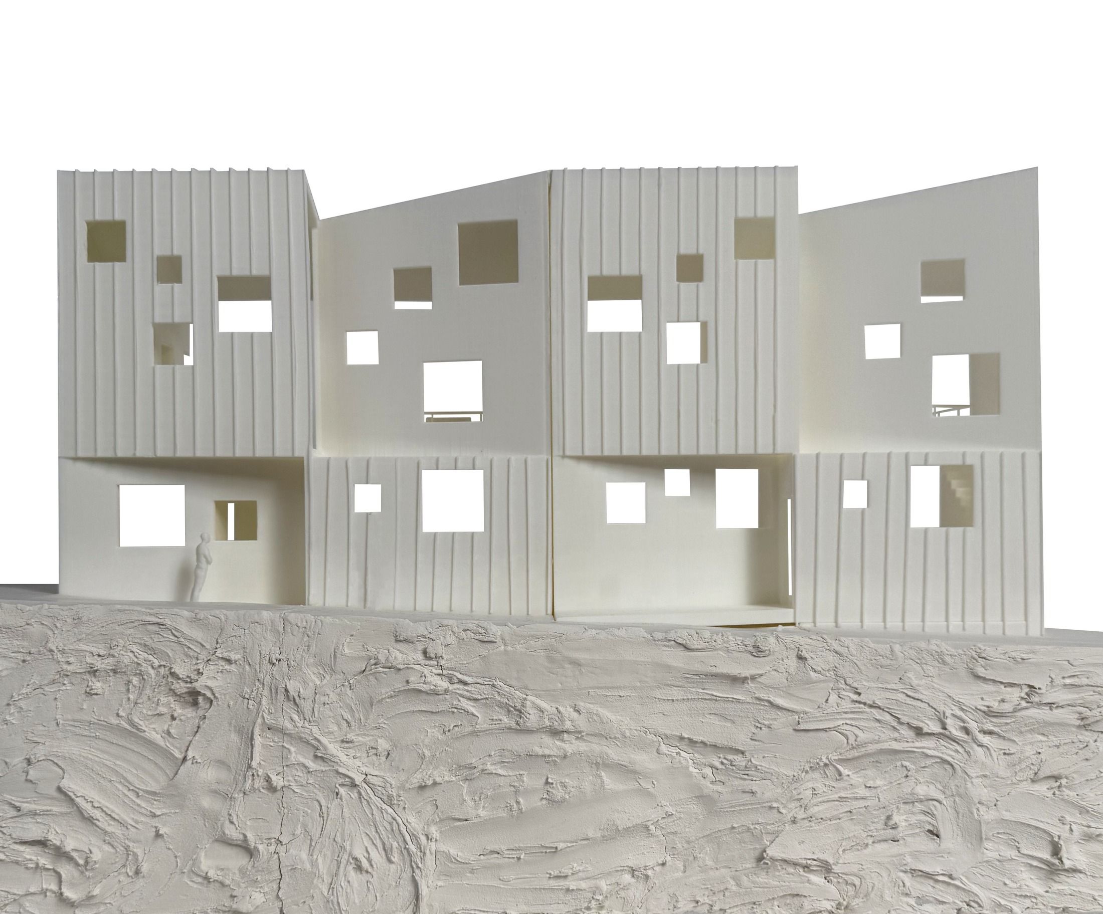 Physical model photograph of a building facade with punched window openings